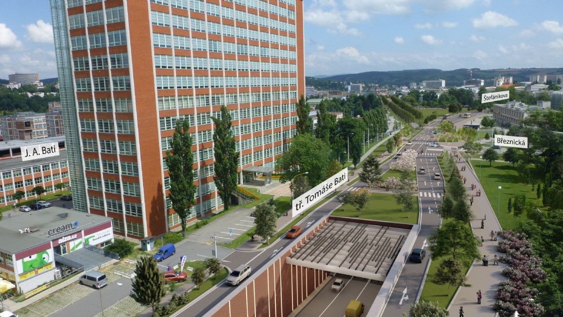 Zlín je rozdělován čtyřpruhovou silnicí s intenzivním provozem motorových vozidel. Nové řešení dopravy ve Zlíně navrhuje silniční tunel pod centrem Zlína.  Na obrázku vidíme před budouvou 21 vjezd do tunelu. (západní portál)